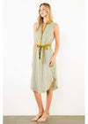 A woman models a sleeveless midi dress with vertical olive green and white stripes, featuring a button-down front, a matching olive green tie belt at the waist, and a high-low hemline, set against a plain white studio background.
