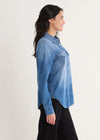 Woman wearing a blue denim shirt on a white background