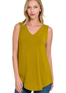  Woman wearing an olive mustard sleeveless top on a white background