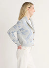 Woman wearing a patterned cardigan on a white background