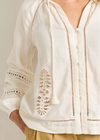 White embroidered blouse with a neutral background
