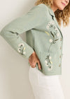 Green jacket with floral embroidery on a plain background