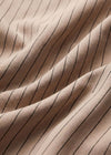 Close-up of beige fabric with black pinstripes