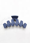 Navy blue hair clip on a white background