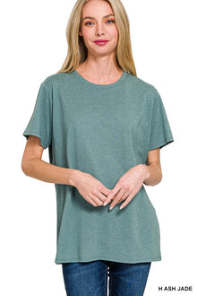  Woman wearing a teal t-shirt on a white background