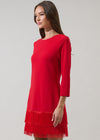 Red dress with a frayed hem on a gray background