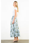 Woman wearing a white t-shirt and a long floral skirt on a white background
