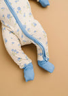 Baby onesie with blue floral pattern on a beige background