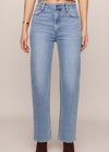 Light blue jeans worn by a person on a beige background