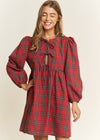 Woman wearing a red plaid dress on a beige background