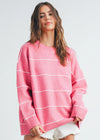 Woman wearing a pink striped sweater on a white background