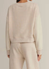 Beige sweatshirt and pants set on a neutral background
