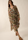 Woman wearing a floral dress on a plain background