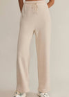 Beige pants worn by a person on a plain background