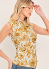 Woman wearing a sleeveless top with a floral pattern on a beige background