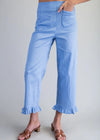 Light blue striped pants with ruffled cuffs worn by a person on a gray background