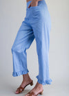 Blue striped pants worn by a person on a plain background