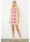 Woman wearing a floral dress against a white background