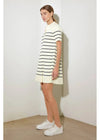 Woman wearing a black and white striped dress against a plain background