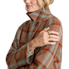 Person wearing a plaid coat with a neutral background