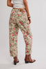 Person wearing floral pants on a plain background