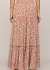 Floral tiered skirt worn by a person on a plain background