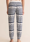 Patterned pajama pants worn by a person on a beige background