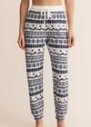 Patterned pajama pants worn by a person on a beige background