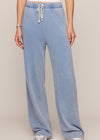 Light blue sweatpants worn by a person on a plain background