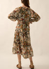 Woman wearing a floral dress on a plain background