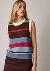 A woman wearing a sleeveless knit sweater vest with horizontal stripes in brown, cream, light blue, and red, paired with a dark brown skirt against a plain light gray studio background.
