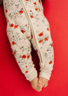 Floral-patterned baby onesie on a red background