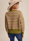 Person wearing a patterned sweater with a neutral background