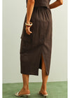 Brown dress worn by a person on a green and white background