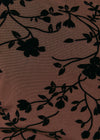A close-up of a brown sheer mesh fabric with a black floral vine pattern.