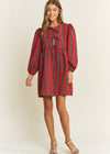 Woman wearing a red plaid dress on a white background