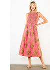 Woman wearing a pink dress with floral pattern on a white background