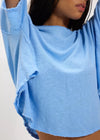 Light blue oversized shirt worn by a person on a plain background