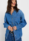 Woman wearing a blue denim shirt on a white background