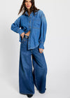 Woman wearing a blue denim outfit on a white background
