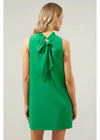 Green dress with a bow detail on the back worn by a model against a plain background