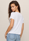 Woman wearing a white t-shirt and blue jeans on a beige background