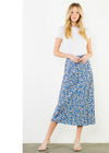 Woman wearing a white t-shirt and blue floral skirt on a white background