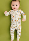 Baby wearing a onesie with vehicle patterns on a green background