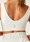 White sports bra worn by a person on a plain background