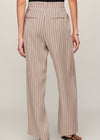 Beige pinstripe pants worn by a person on a plain background