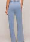 Light blue jeans worn by a person on a plain background
