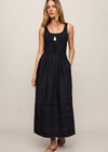 Woman wearing a black sleeveless dress against a beige background