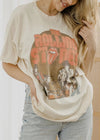 Person wearing a 'The Rolling Stones' t-shirt with a graphic design.