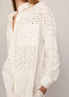 White textured shirt worn by a person on a plain background
